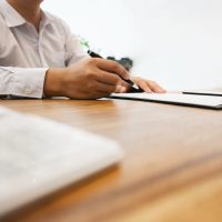 public official writing on his clipboard