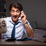 Young financial manager working late at night in office