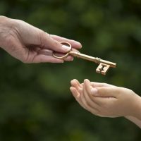 adult hands key to child