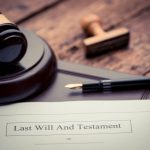 Last Will and testament document on wooden table close up